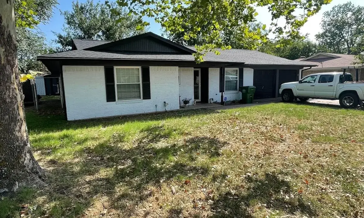 Professional roofing crew working on a residential roof in Warwick